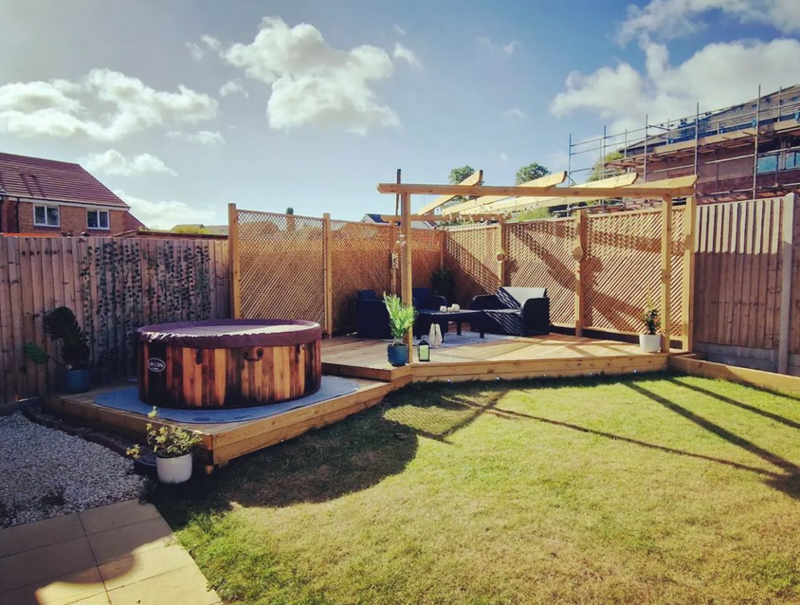 Decking area with pagoda and drop down area for hot tub.